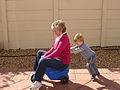 120px-Child_pushing_grandmother_on_plastic_tricycle
